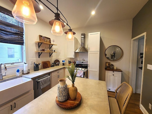 313 S 4th St, Oregon, IL 61061 - kitchen with wall chimney range hood, stainless steel appliances, tasteful backsplash, light countertops, and decorative light fixtures