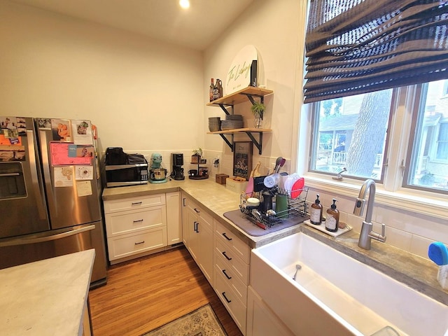 313 S 4th St, Oregon, IL 61061 - kitchen featuring appliances with stainless steel finishes, open shelves, light countertops, white cabinetry, and light wood-type flooring
