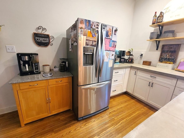 313 S 4th St, Oregon, IL 61061 - kitchen with stainless steel fridge, light wood finished floors, open shelves, and light countertops