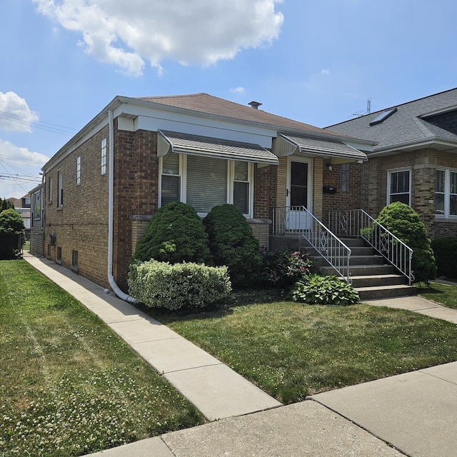 5823 W Addison St, Chicago, IL 60634 - view of front of property featuring brick siding and a front lawn
