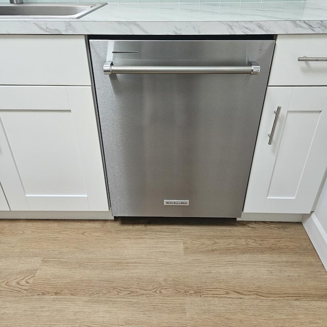 5823 W Addison St, Chicago, IL 60634 - kitchen view of stainless steel dishwasher, white cabinetry, and light wood finished floors
