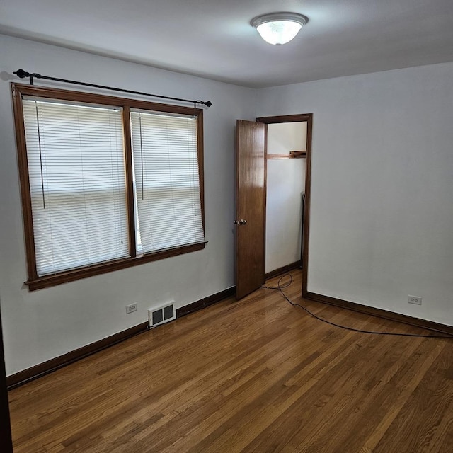 5823 W Addison St, Chicago, IL 60634 - unfurnished room featuring wood finished floors and baseboards
