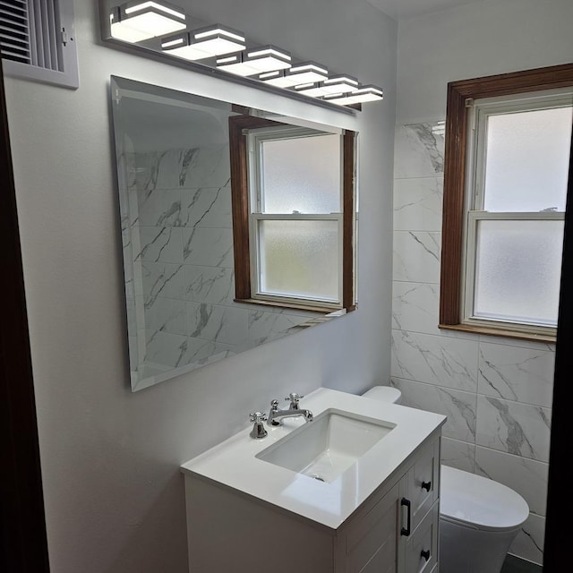 5823 W Addison St, Chicago, IL 60634 - bathroom with plenty of natural light, vanity, and tile walls