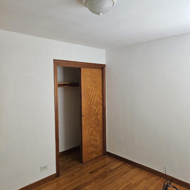 5823 W Addison St, Chicago, IL 60634 - unfurnished bedroom featuring a closet and wood finished floors