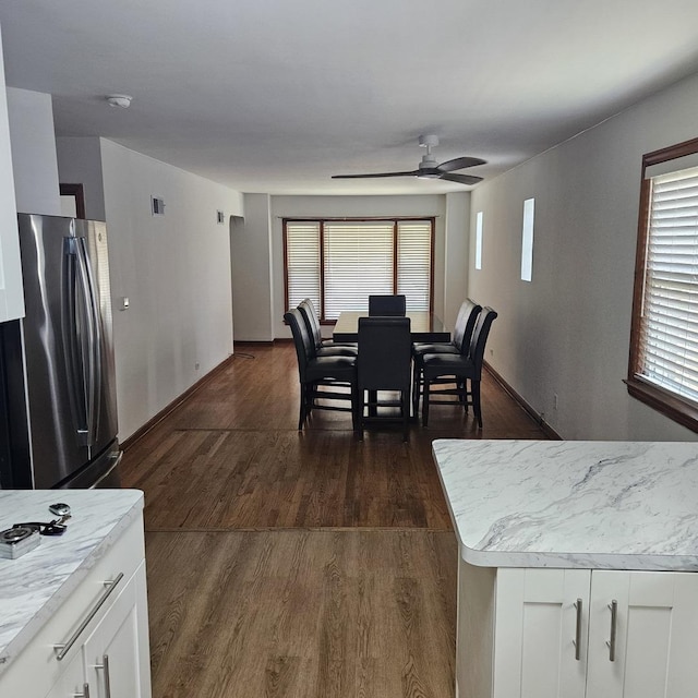 5823 W Addison St, Chicago, IL 60634 - dining space featuring a ceiling fan, healthy amount of natural light, and dark wood-style flooring