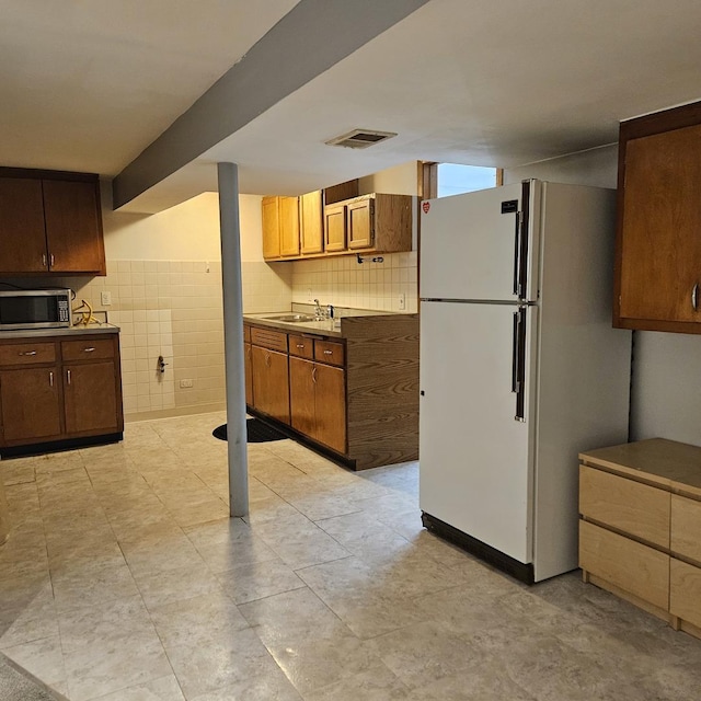 5823 W Addison St, Chicago, IL 60634 - kitchen featuring freestanding refrigerator and stainless steel microwave