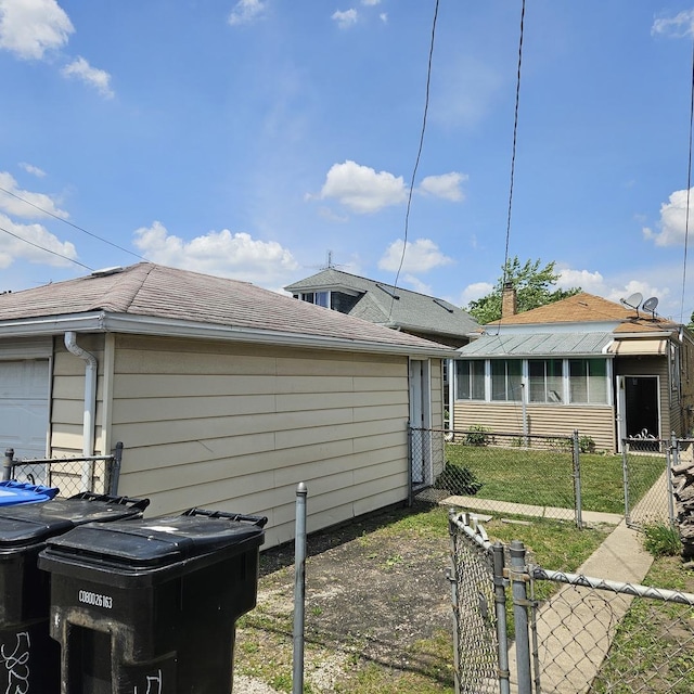 5823 W Addison St, Chicago, IL 60634 - view of home's exterior with a gate, a garage, and a sunroom