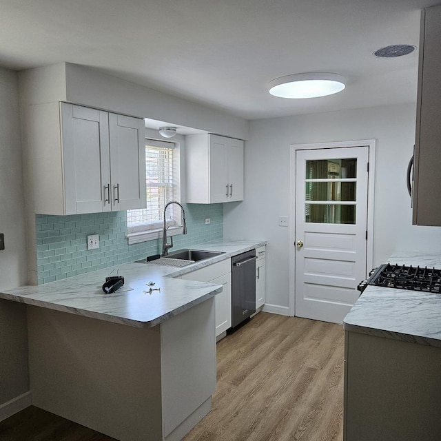 5823 W Addison St, Chicago, IL 60634 - kitchen featuring dishwasher, a peninsula, light wood-style floors, and white cabinetry