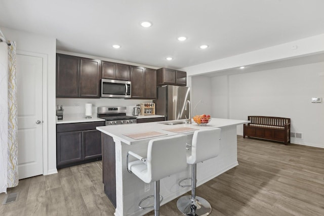 1917 Turtle Creek Ct, Aurora, IL 60503 - kitchen featuring appliances with stainless steel finishes, light countertops, recessed lighting, light wood-style floors, and dark brown cabinetry