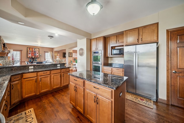26200 W Chatham Dr, Plainfield, IL 60585 - kitchen featuring appliances with stainless steel finishes, brown cabinets, dark wood-type flooring, and dark stone countertops