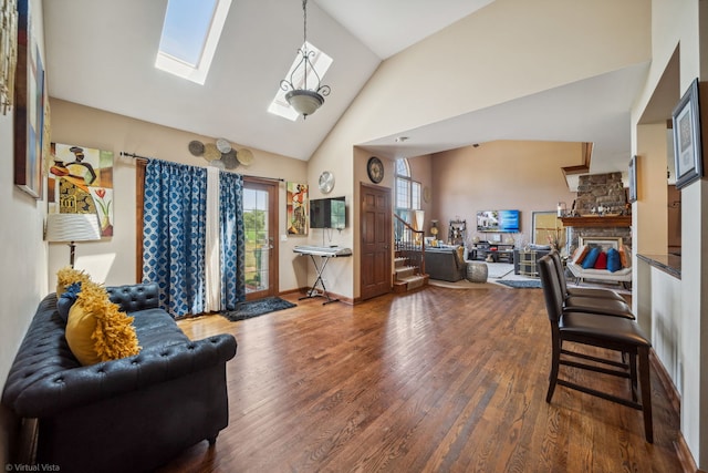 26200 W Chatham Dr, Plainfield, IL 60585 - living area featuring high vaulted ceiling, a skylight, wood finished floors, stairway, and a fireplace