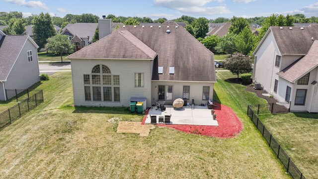 26200 W Chatham Dr, Plainfield, IL 60585 - rear view of house featuring a patio, roof with shingles, a chimney, a residential view, and a fenced backyard
