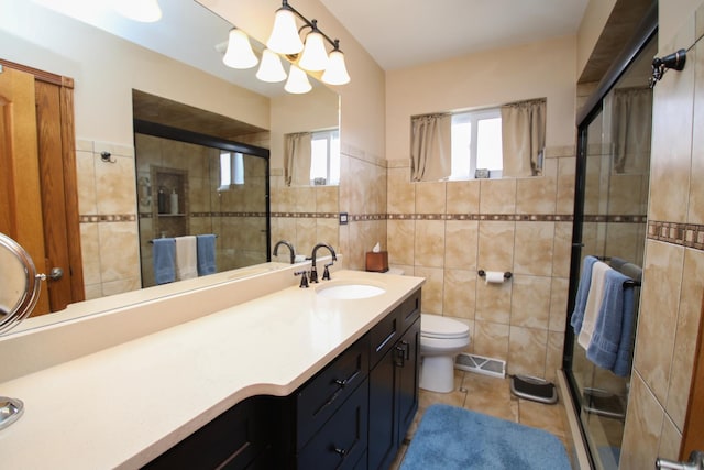 5518 S Melvina Ave, Chicago, IL 60638 - bathroom featuring tile walls, tile patterned floors, plenty of natural light, a shower stall, and a wainscoted wall
