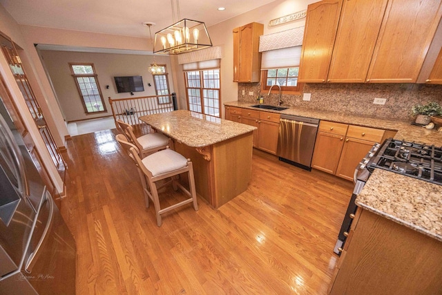 14803 S Hawthorn Cir, Plainfield, IL 60544 - kitchen with dishwasher, range with gas cooktop, light wood finished floors, a kitchen island, and a chandelier