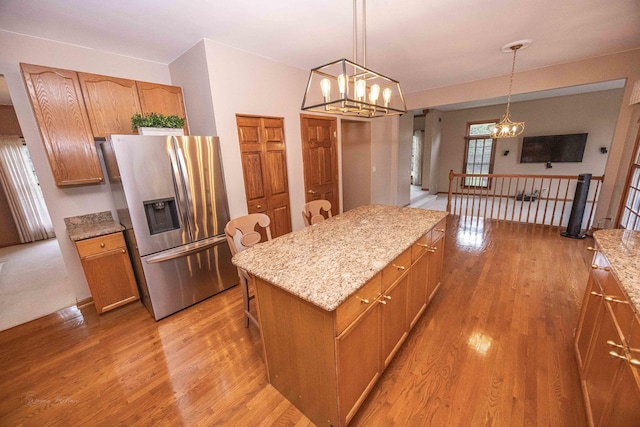 14803 S Hawthorn Cir, Plainfield, IL 60544 - kitchen with a chandelier, stainless steel fridge, light wood finished floors, and a kitchen island