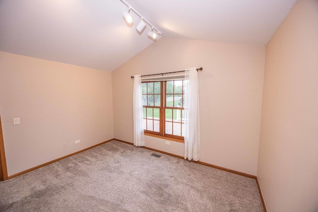 14803 S Hawthorn Cir, Plainfield, IL 60544 - empty room featuring rail lighting, lofted ceiling, and carpet floors