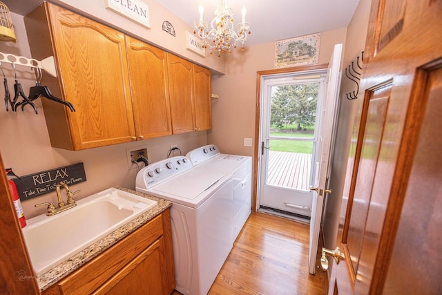 14803 S Hawthorn Cir, Plainfield, IL 60544 - laundry area with cabinet space, washing machine and dryer, light wood-type flooring, and a chandelier