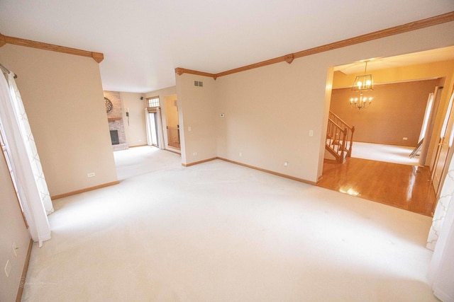 14803 S Hawthorn Cir, Plainfield, IL 60544 - carpeted empty room featuring crown molding, a fireplace, stairs, and a chandelier