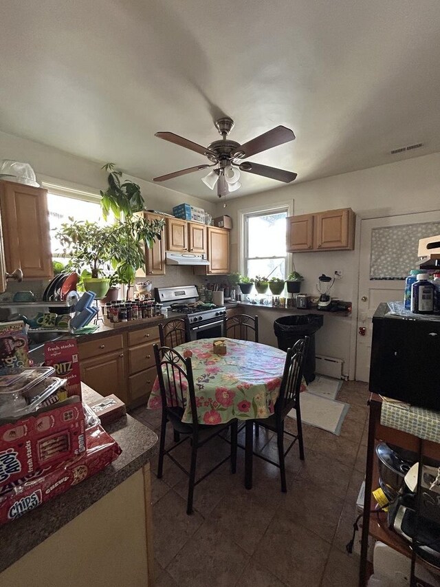 3247 W Berteau Ave, Chicago, IL 60618 - dining room with ceiling fan and dark tile patterned floors