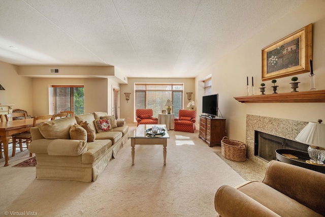 865 E 22nd St Unit 214, Lombard, IL 60148 - living area featuring light colored carpet, plenty of natural light, a textured ceiling, and a premium fireplace