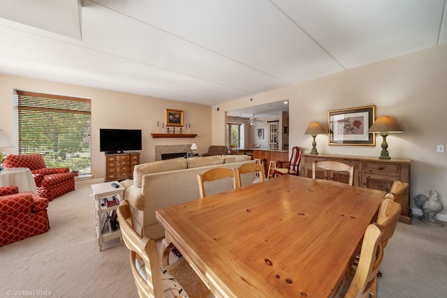 865 E 22nd St Unit 214, Lombard, IL 60148 - dining space with light carpet, a fireplace, and a ceiling fan