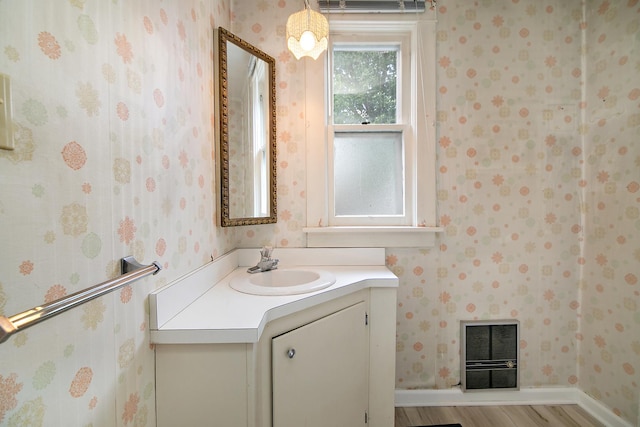 866 S Evergreen Ave, Kankakee, IL 60901 - bathroom featuring vanity, wood finished floors, wallpapered walls, and heating unit