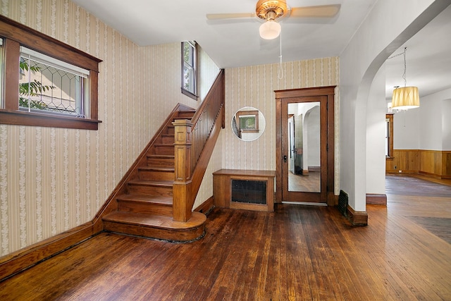 866 S Evergreen Ave, Kankakee, IL 60901 - entrance foyer with wallpapered walls, hardwood / wood-style flooring, arched walkways, a ceiling fan, and stairs