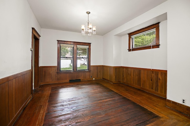 866 S Evergreen Ave, Kankakee, IL 60901 - unfurnished room featuring plenty of natural light, a wainscoted wall, wood-type flooring, a chandelier, and wooden walls