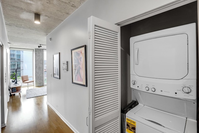 611 S Wells St Unit 1304, Chicago, IL 60607 - washroom featuring stacked washing machine and dryer and wood finished floors