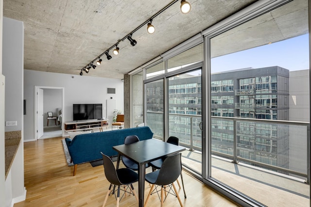 611 S Wells St Unit 1304, Chicago, IL 60607 - dining area featuring wood finished floors, rail lighting, and floor to ceiling windows