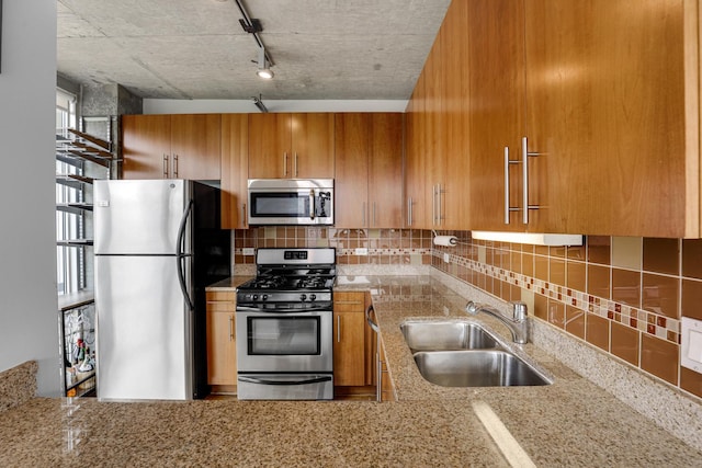 611 S Wells St Unit 1304, Chicago, IL 60607 - kitchen with stainless steel appliances, decorative backsplash, brown cabinets, and light stone countertops