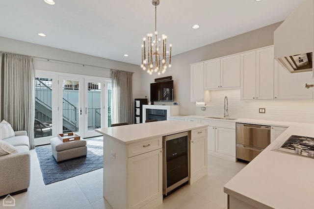 1807 W Ohio St, Chicago, IL 60622 - kitchen featuring wine cooler, range hood, open floor plan, appliances with stainless steel finishes, and recessed lighting