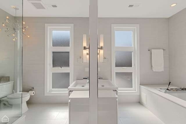 1807 W Ohio St, Chicago, IL 60622 - full bathroom with tile patterned flooring, vanity, healthy amount of natural light, and a garden tub