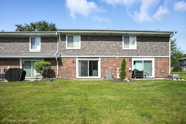 10 Cour Masson Unit 10, Palos Hills, IL 60465 - rear view of property featuring a lawn and brick siding