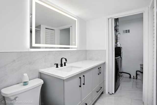 10 Cour Masson Unit 10, Palos Hills, IL 60465 - bathroom featuring marble finish flooring, vanity, and washing machine and clothes dryer