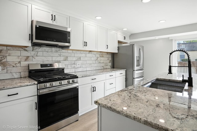 10 Cour Masson Unit 10, Palos Hills, IL 60465 - kitchen featuring stainless steel appliances, white cabinetry, light stone countertops, backsplash, and recessed lighting