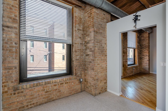 1040 W Adams St Unit 257, Chicago, IL 60607 - empty room featuring brick wall and wood finished floors