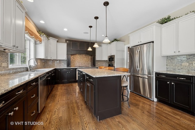 605 Red Cypress Dr, Cary, IL 60013 - kitchen featuring appliances with stainless steel finishes, white cabinets, dark wood-style flooring, tasteful backsplash, and recessed lighting