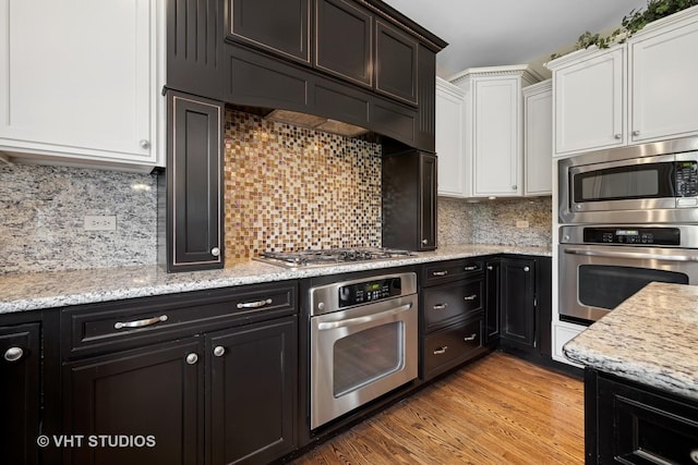 605 Red Cypress Dr, Cary, IL 60013 - kitchen with appliances with stainless steel finishes, white cabinets, and light stone counters