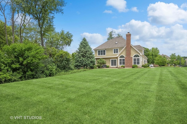 605 Red Cypress Dr, Cary, IL 60013 - rear view of property featuring a lawn and a chimney
