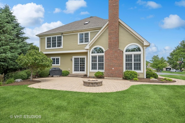 605 Red Cypress Dr, Cary, IL 60013 - back of property featuring a patio area, a chimney, a yard, and an outdoor fire pit