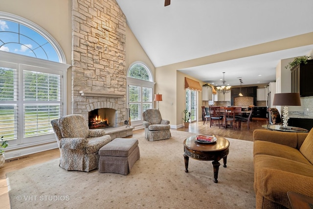 605 Red Cypress Dr, Cary, IL 60013 - living room featuring wood finished floors, high vaulted ceiling, a chandelier, and a fireplace