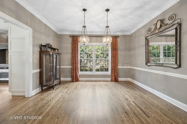 605 Red Cypress Dr, Cary, IL 60013 - unfurnished dining area featuring a chandelier, wood finished floors, and ornamental molding