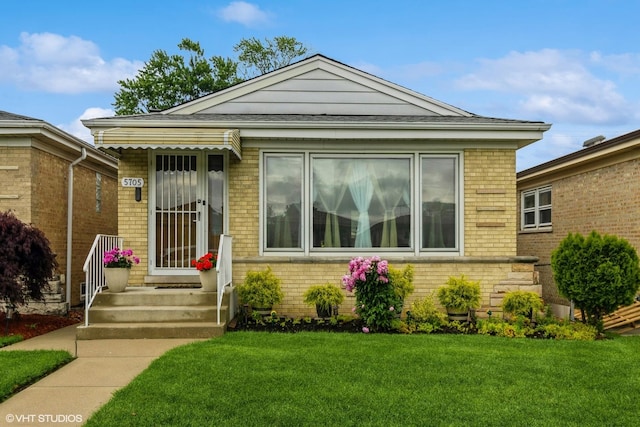 5705 N Oketo Ave, Chicago, IL 60631 - view of front of home featuring brick siding and a front yard