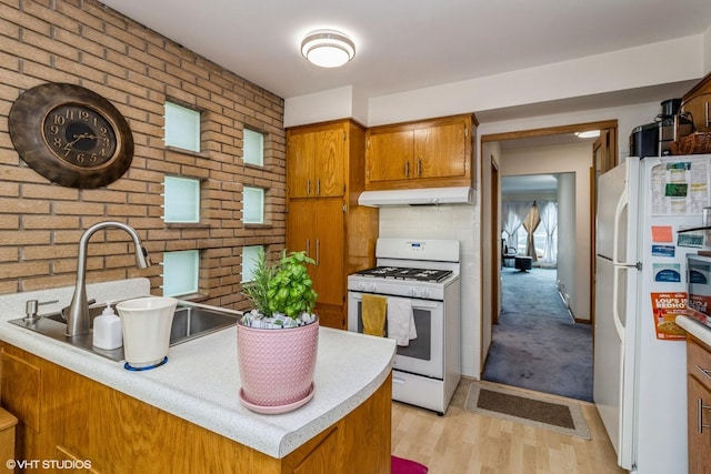5705 N Oketo Ave, Chicago, IL 60631 - kitchen with white appliances, under cabinet range hood, brown cabinets, and light countertops