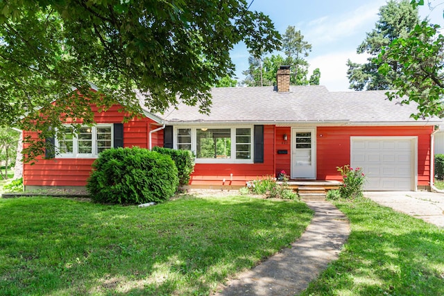 403 W 2nd St, Genoa, IL 60135 - view of front of property with a garage, concrete driveway, a chimney, and a front yard
