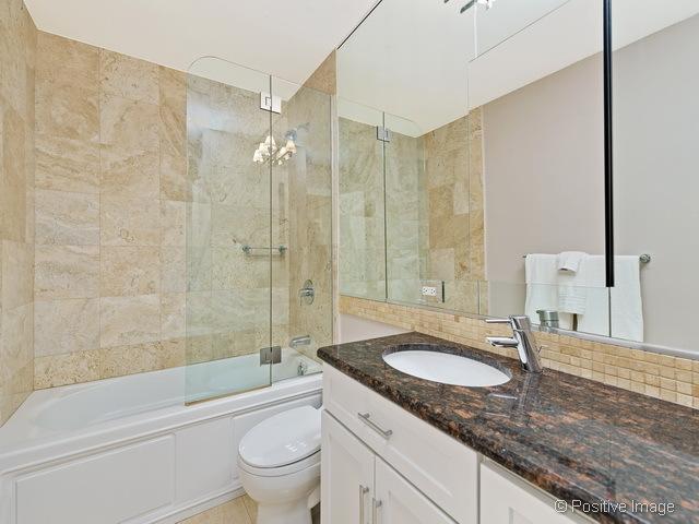 1550 N Lake Shore Dr Unit 3G, Chicago, IL 60610 - full bathroom with vanity, combined bath / shower with glass door, and backsplash