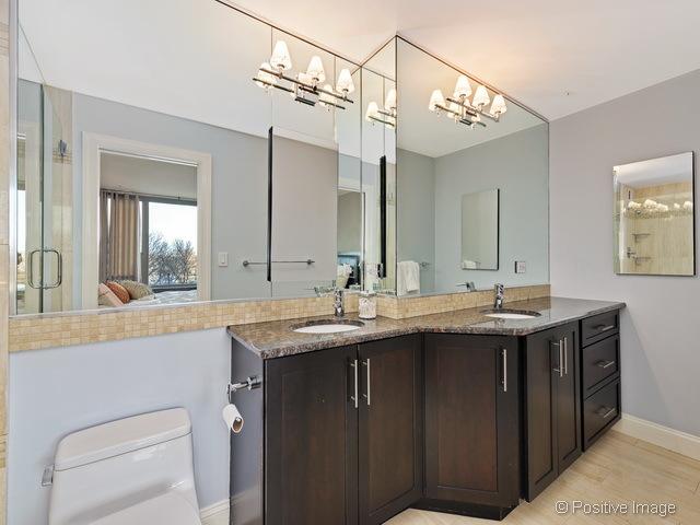 1550 N Lake Shore Dr Unit 3G, Chicago, IL 60610 - ensuite bathroom featuring double vanity, wood finished floors, a chandelier, and a shower with door