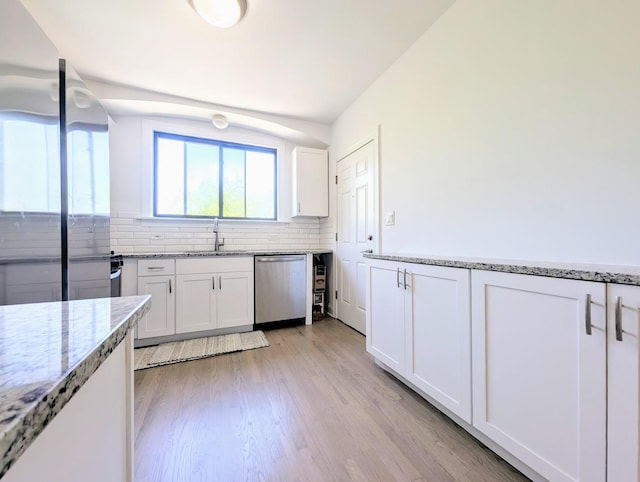 5655 N Spaulding Ave Unit 2W, Chicago, IL 60659 - kitchen featuring stainless steel dishwasher, white cabinets, backsplash, light wood-type flooring, and light stone countertops