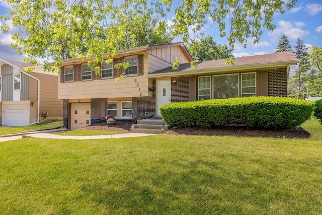 3317 Birchwood Dr, Hazel Crest, IL 60429 - split level home featuring brick siding, a garage, a front yard, and board and batten siding